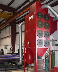 Micro Air's RP8, equipped with SA4000H Spark Arrestor, mounted to the side of the collector, and ducted to a plasma table, captures smoke and fumes generated in plasma cutting